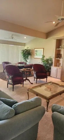 a living room with furniture and a lamp