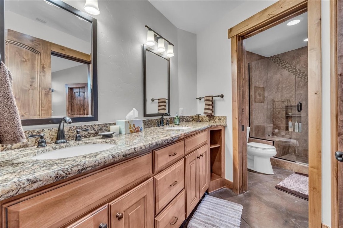73 Last Chance Lane Dillon, CO 80435 - Photo 32 of 46 a bathroom with a granite countertop sink mirror and a toilet