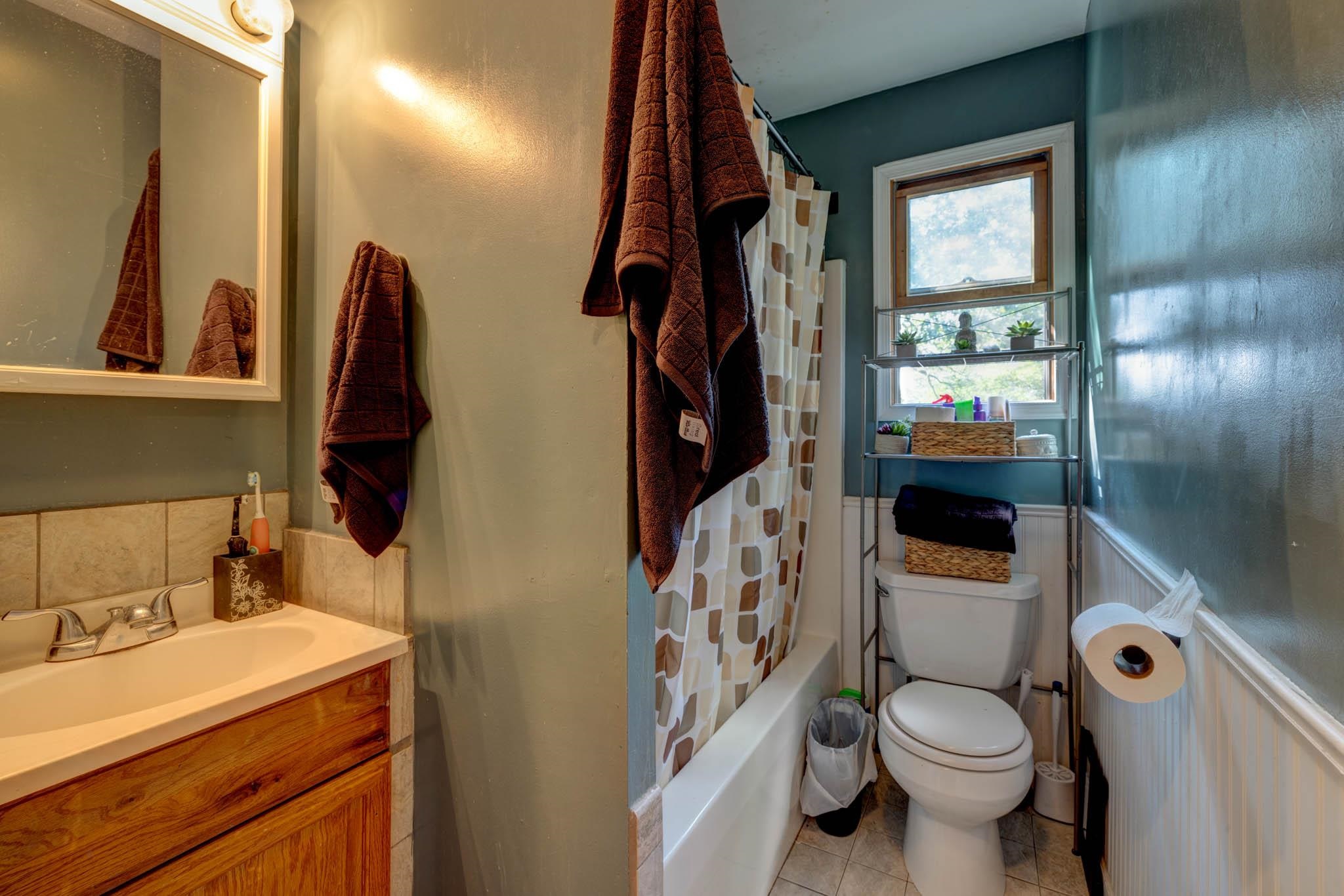 106 Delair Road Cape May, NJ 08204 - Photo 13 of 28 a bathroom with a sink a toilet and a mirror