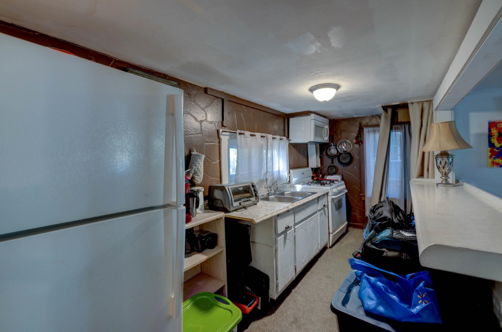 106 Delair Road Cape May, NJ 08204 - Photo 22 of 28 a kitchen with a sink stove and refrigerator