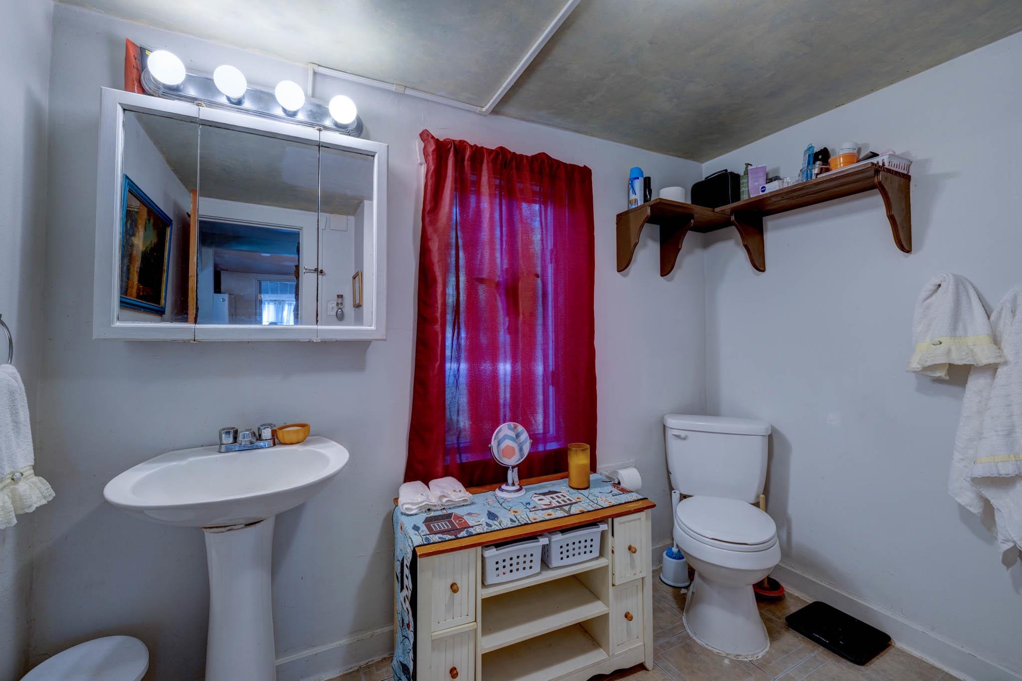 106 Delair Road Cape May, NJ 08204 - Photo 23 of 28 a bathroom with a toilet a sink and mirror