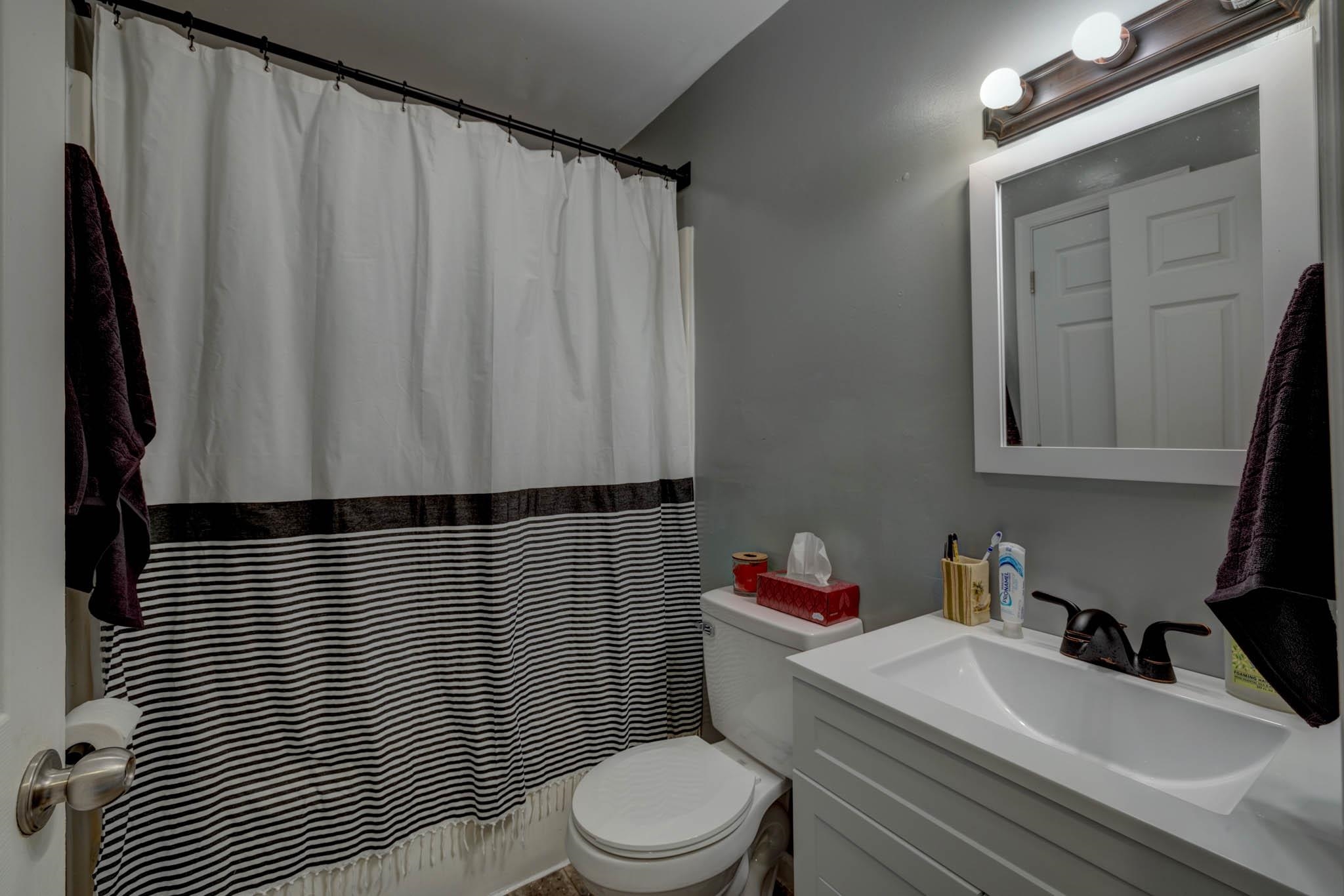 106 Delair Road Cape May, NJ 08204 - Photo 10 of 28 a bathroom with a sink toilet and shower