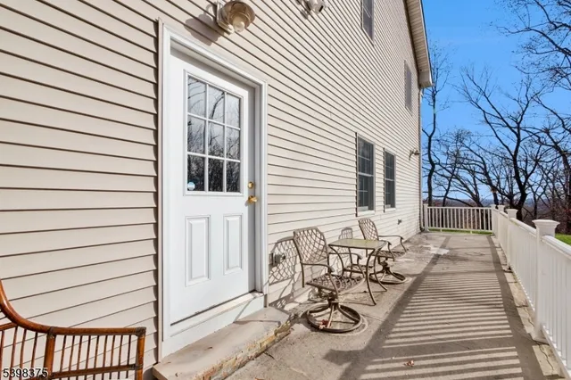 a view of a patio with couches and table and chairs with wooden floor