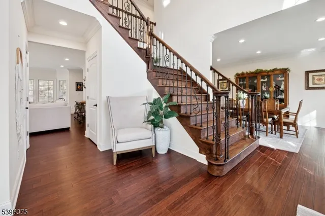 a view of entryway with wooden floor and stairs