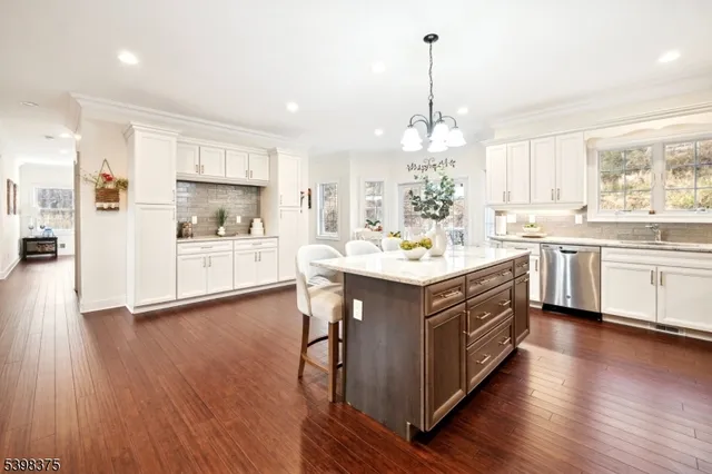 a kitchen with a sink cabinets and wooden floor