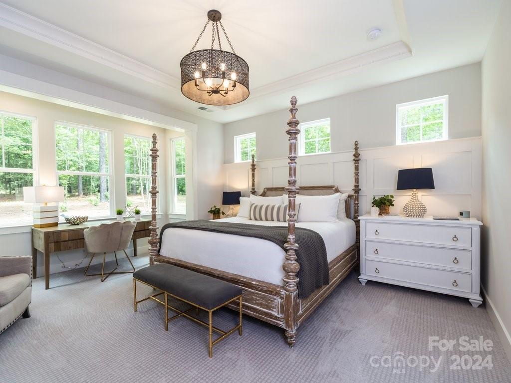 4298 Persimmon Road Lancaster, SC 29720 - Photo 11 of 46 a spacious bedroom with a bed and a chandelier