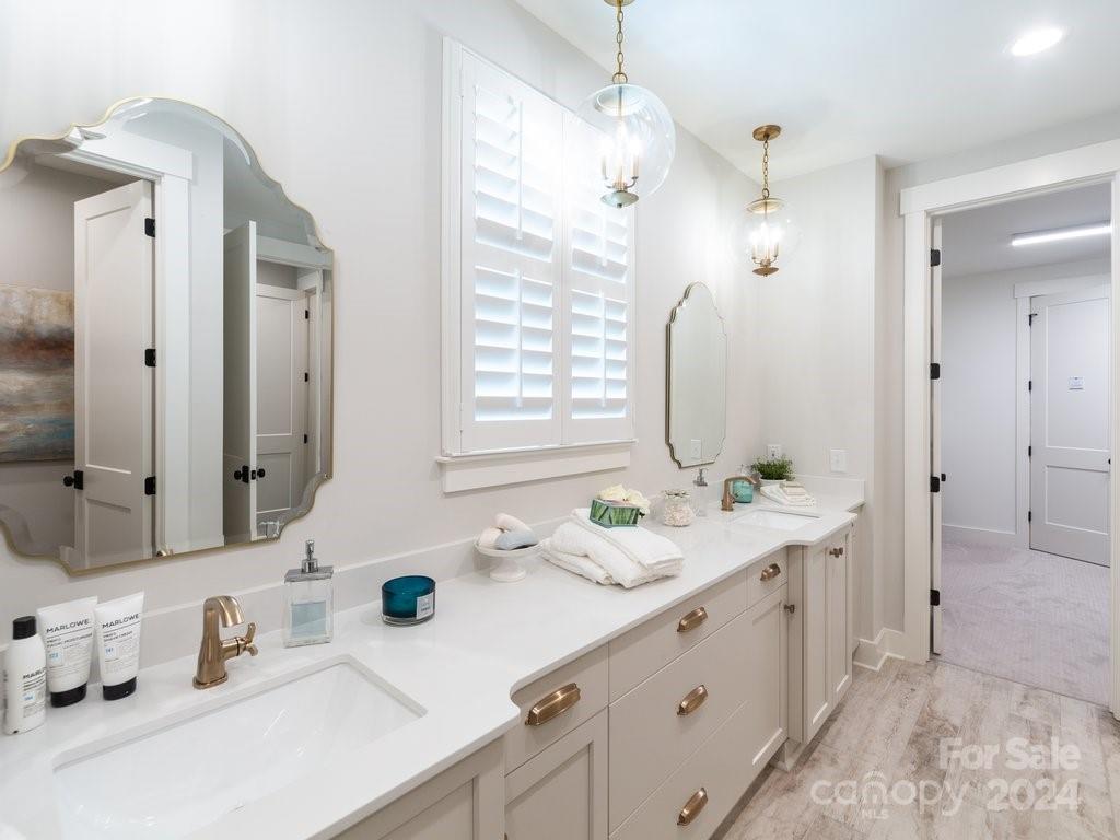 4298 Persimmon Road Lancaster, SC 29720 - Photo 17 of 46 a spacious bathroom with double vanity sinks a mirror and a shower
