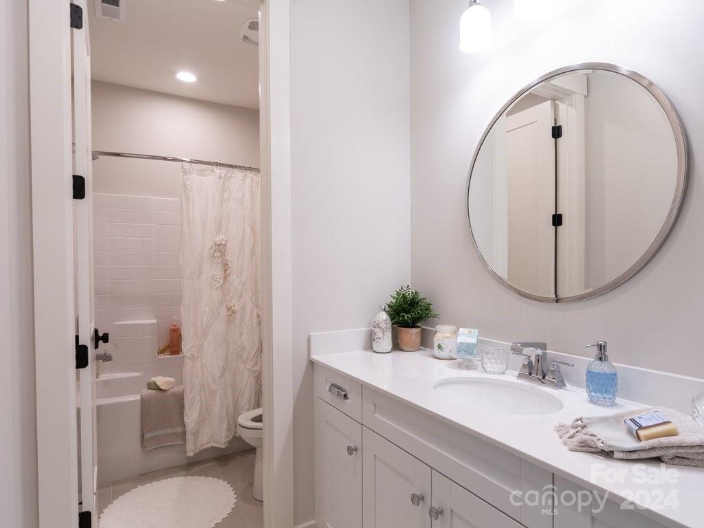 4298 Persimmon Road Lancaster, SC 29720 - Photo 36 of 46 a bathroom with a granite countertop sink mirror toilet and shower