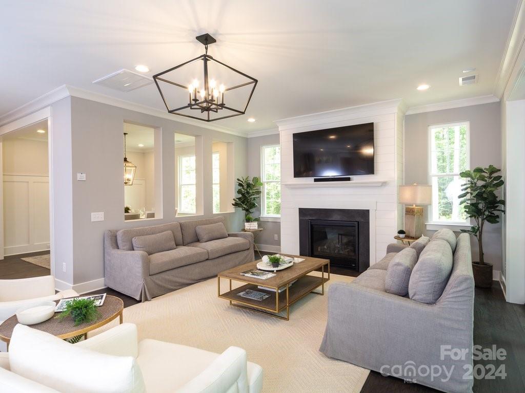 4298 Persimmon Road Lancaster, SC 29720 - Photo 7 of 46 a living room with furniture a flat screen tv and a fireplace