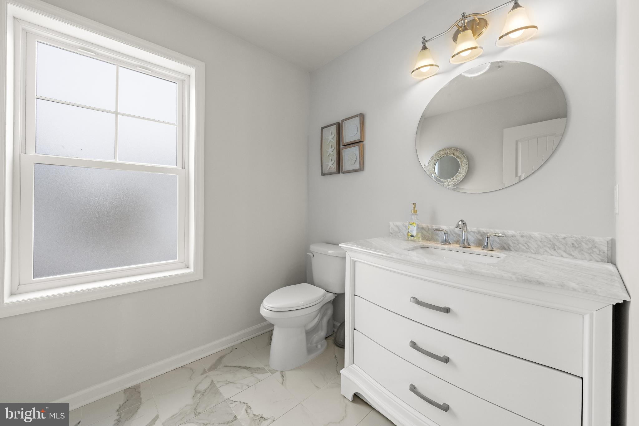 106 West 26th Street Ship Bottom, NJ 08008 - Photo 14 of 15 a bathroom with a sink a toilet and a mirror