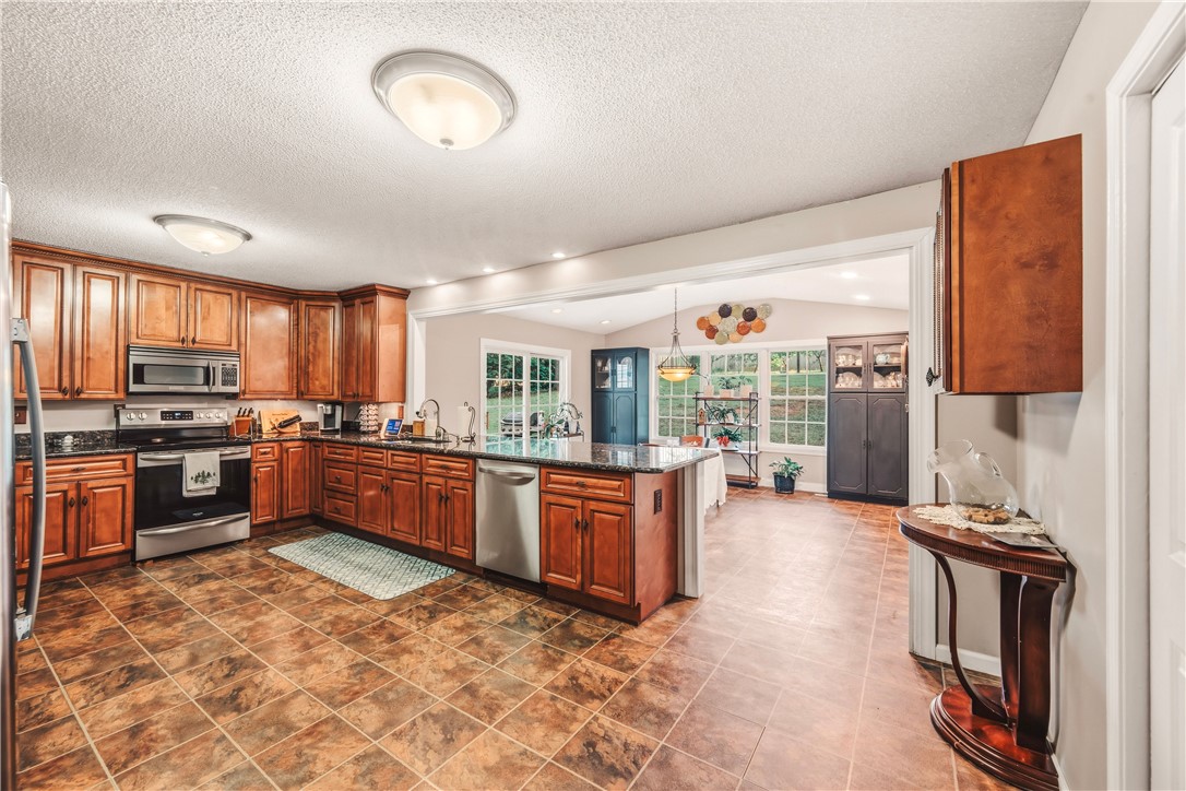 2001 Ridgeview Lane Seneca, SC 29678 - Photo 8 of 27 A spacious kitchen with rich wood cabinetry and ample counter space flows into a naturally illuminated dining area.