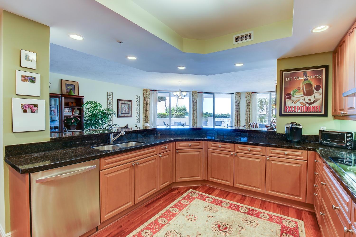 700 Highway 1, Unit 103 Jupiter, FL 33477 - Photo 12 of 36 a kitchen with stainless steel appliances granite countertop a sink and cabinets