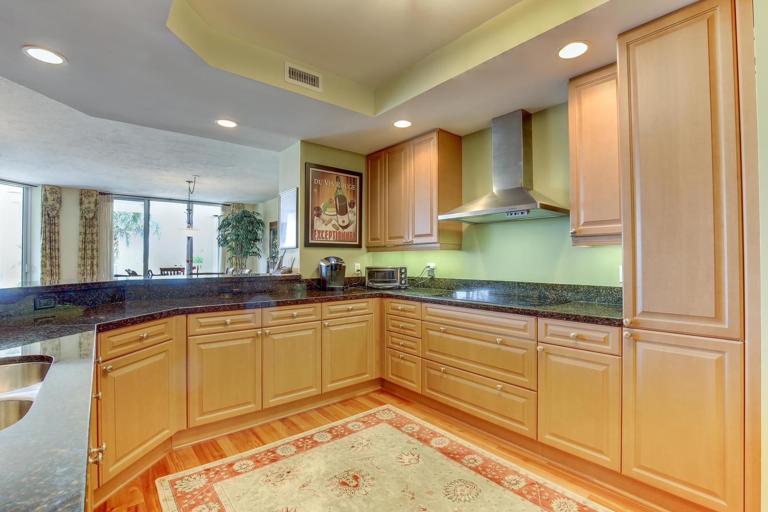 700 Highway 1, Unit 103 Jupiter, FL 33477 - Photo 13 of 36 a kitchen with a sink and a wooden floor