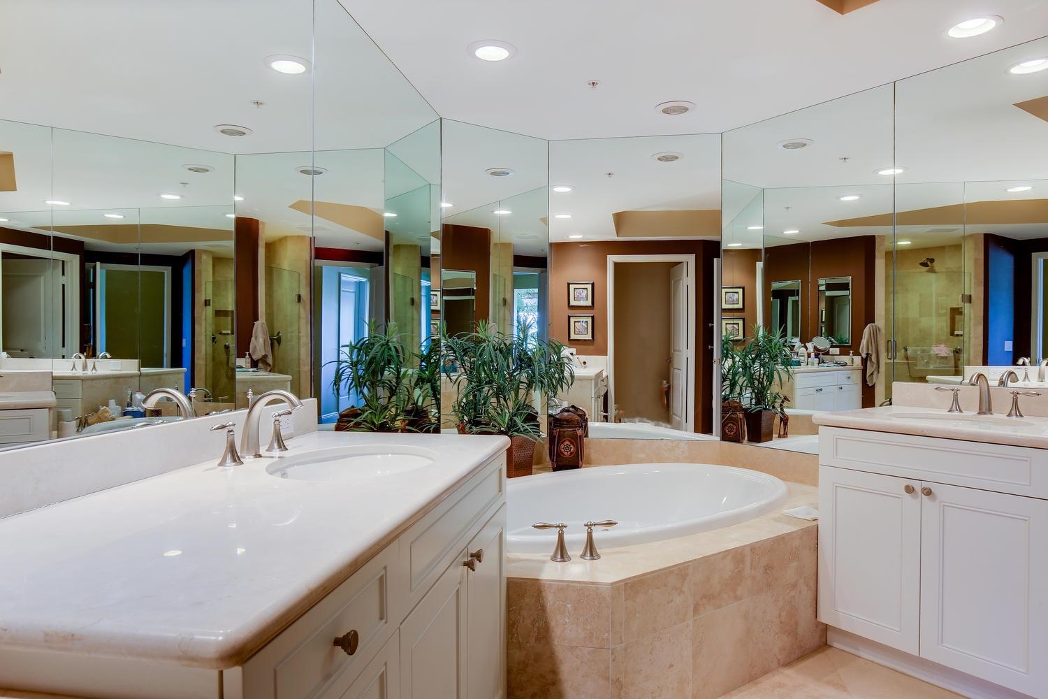 700 Highway 1, Unit 103 Jupiter, FL 33477 - Photo 17 of 36 a bathroom with a tub a sink and a large mirror
