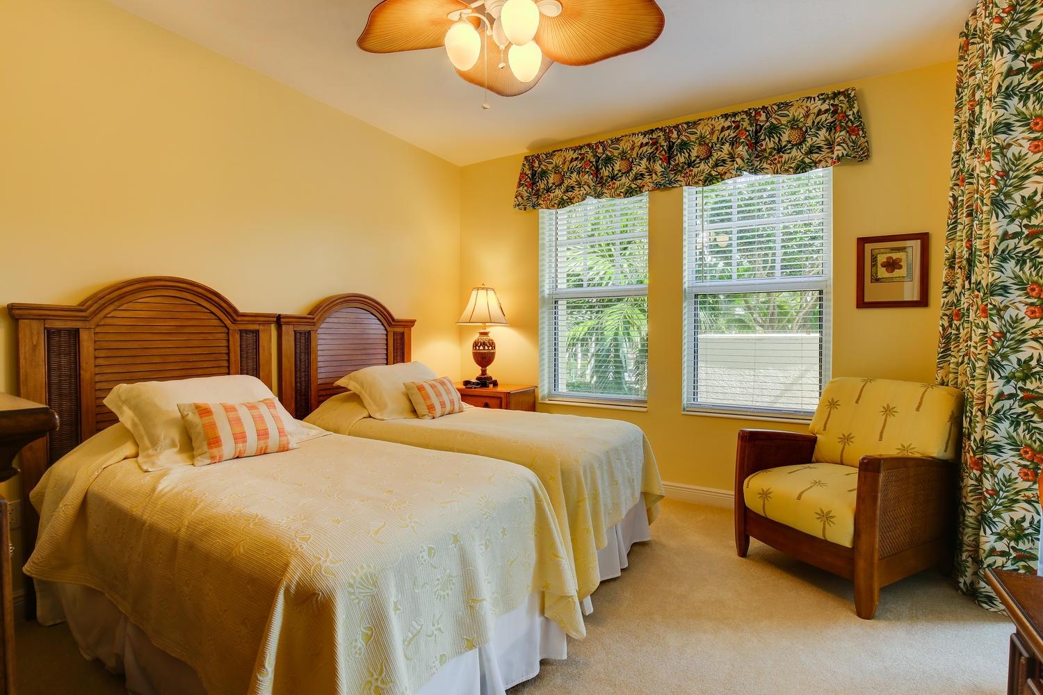 700 Highway 1, Unit 103 Jupiter, FL 33477 - Photo 20 of 36 a bedroom with two beds and a chandelier