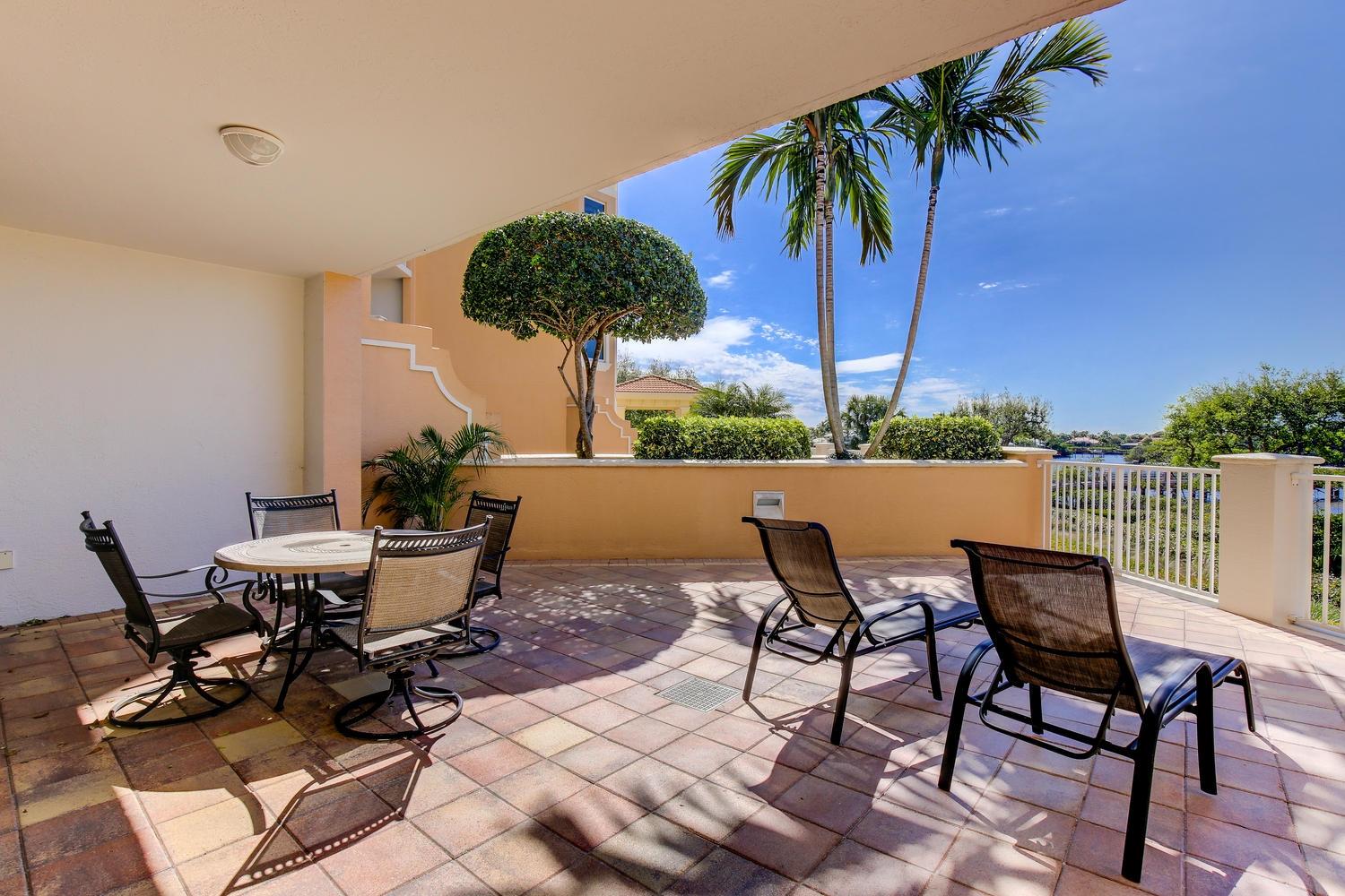 700 Highway 1, Unit 103 Jupiter, FL 33477 - Photo 22 of 36 a view of a patio with a table and chairs