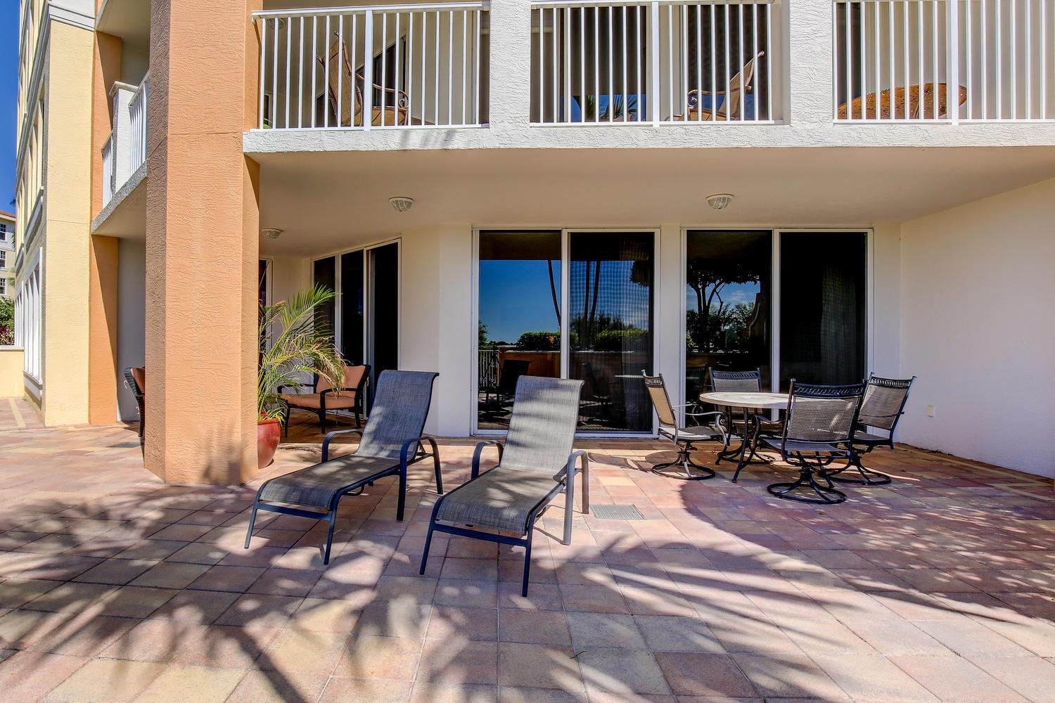 700 Highway 1, Unit 103 Jupiter, FL 33477 - Photo 23 of 36 a view of a dinning table and chairs in the patio