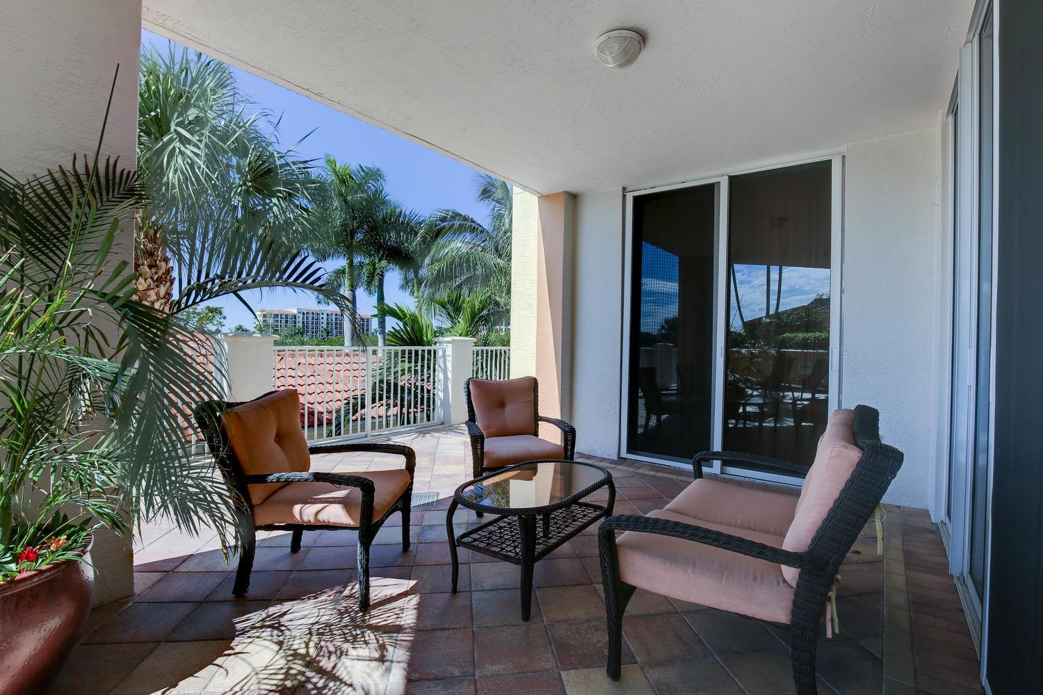 700 Highway 1, Unit 103 Jupiter, FL 33477 - Photo 24 of 36 a balcony with furniture and wooden floor