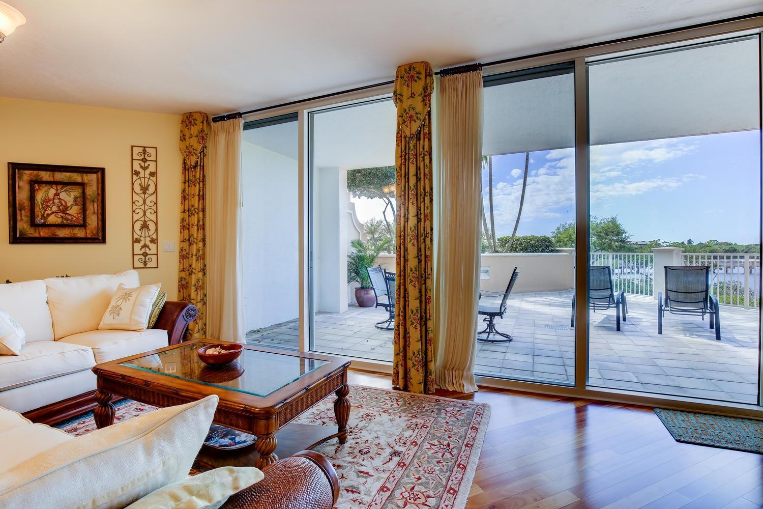 700 Highway 1, Unit 103 Jupiter, FL 33477 - Photo 4 of 36 a living room with furniture and a floor to ceiling window