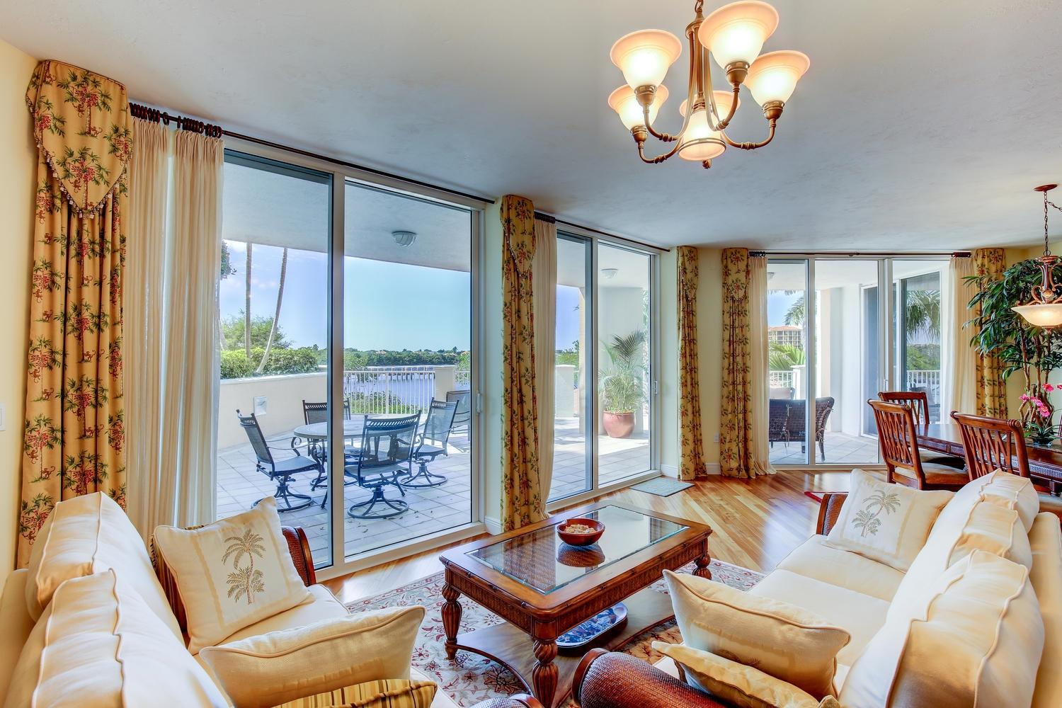 700 Highway 1, Unit 103 Jupiter, FL 33477 - Photo 5 of 36 a living room with furniture couches and large windows