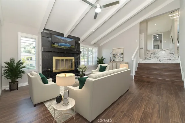 an empty room with wooden floor and mirror