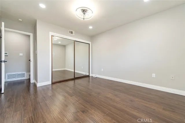 a spacious bedroom with a bed and a large window