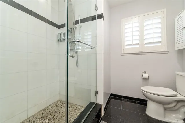 a view of swimming pool with outdoor seating and trees in the background