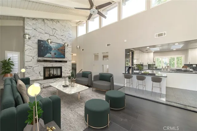 a living room with furniture a fireplace and a flat screen tv