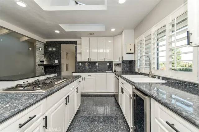 a kitchen with stainless steel appliances granite countertop a stove sink and cabinets