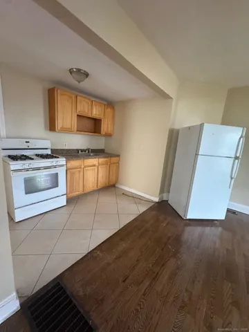 a kitchen with granite countertop a stove and a refrigerator