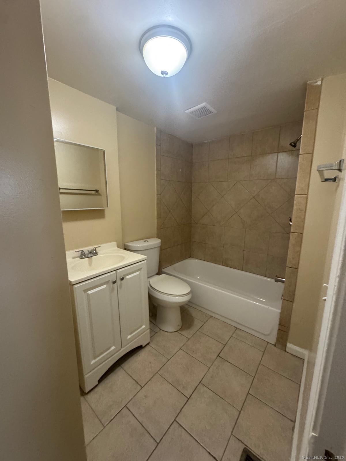 49 Dover Street, Unit 2F Bridgeport, CT 06610 - Photo 2 of 3 a bathroom with a sink a toilet and shower