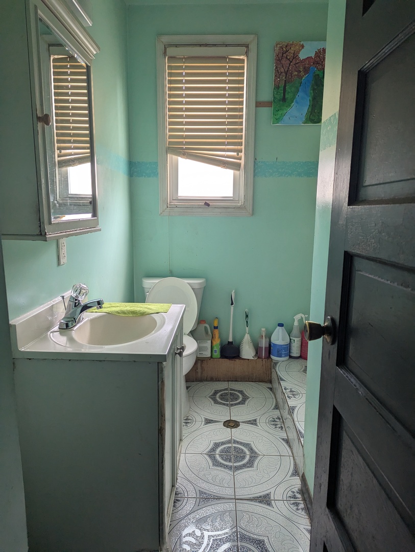 7548 West 61st Street Summit, IL 60501 - Photo 12 of 20 a bathroom with a sink a toilet and a mirror