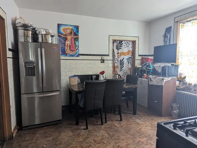 a kitchen with stainless steel appliances granite countertop a refrigerator and a stove top oven