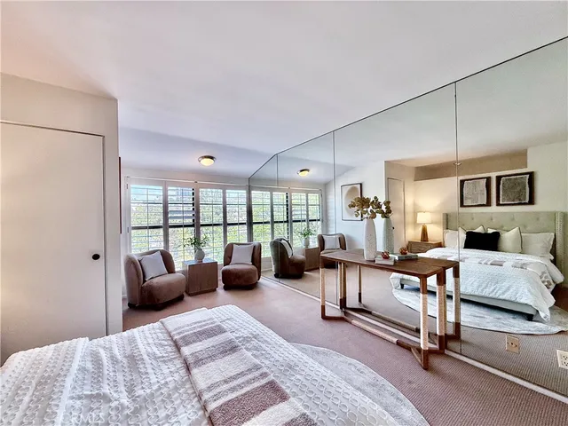 a bedroom with bed couch and window