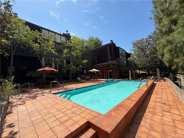 a patio with glass top table and chairs