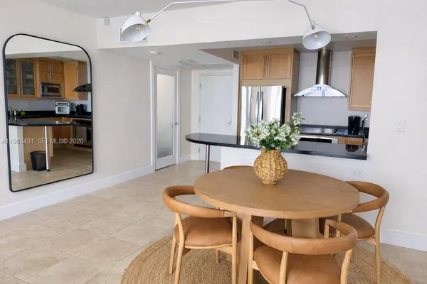 a dining room with furniture and window