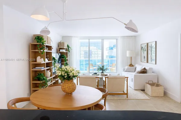 a dining room with furniture and a potted plant