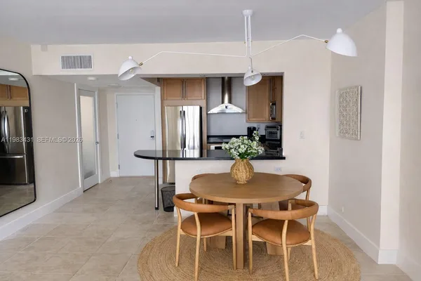 a dining room with furniture and wooden floor