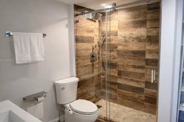 a utility room with cabinets washer and dryer