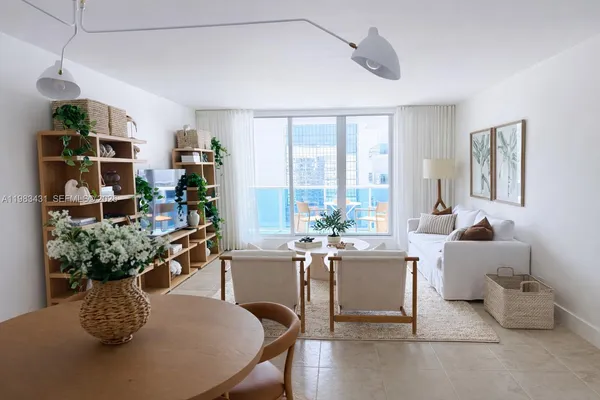 a living room with furniture potted plant and a window