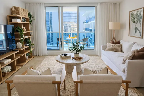 a living room with furniture and a potted plant