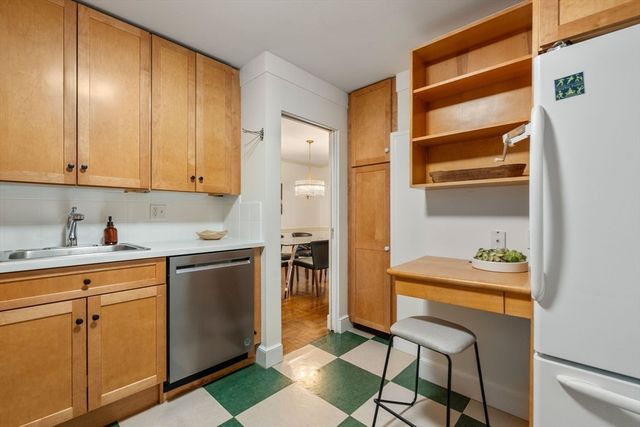 a kitchen with stainless steel appliances a sink and cabinets