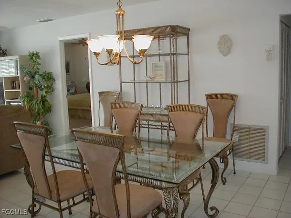 a view of a dining room with furniture and a chandelier
