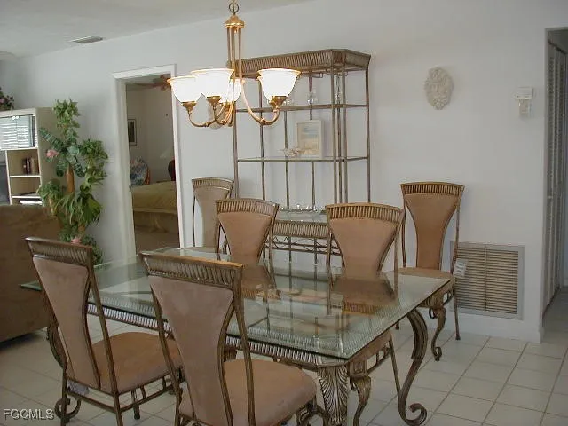 a view of a dining room with furniture and a chandelier