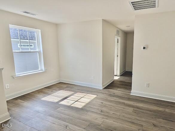 1003 Shovelhead Drive Durham, NC 27703 - Photo 12 of 21 an empty room with wooden floor cabinet and windows
