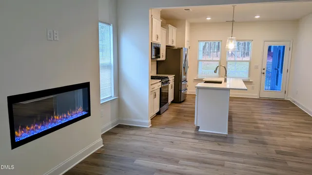 a kitchen with stainless steel appliances granite countertop a refrigerator a stove top oven a sink and dishwasher