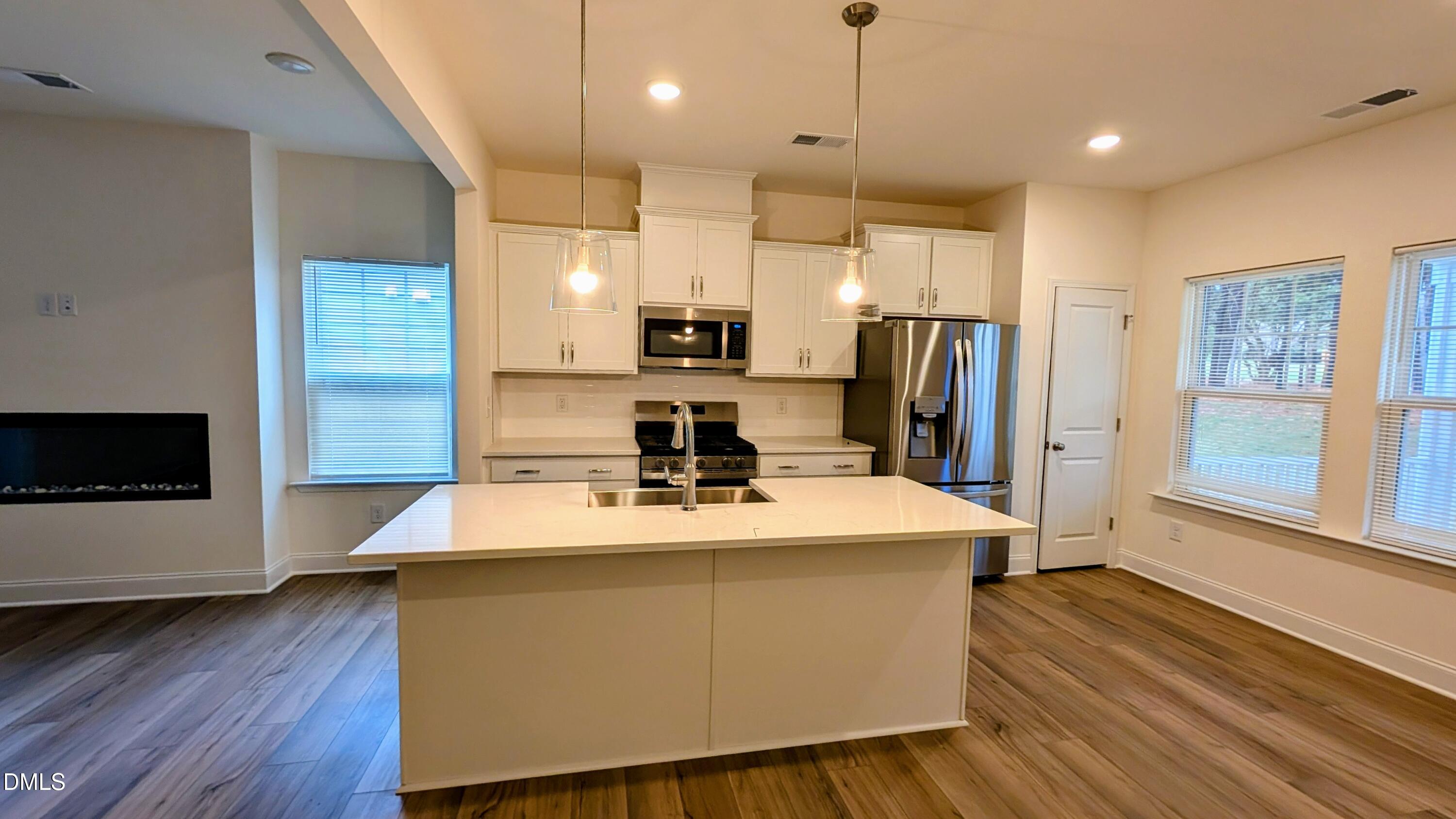 1003 Shovelhead Drive Durham, NC 27703 - Photo 21 of 21 a kitchen with kitchen island a sink appliances and cabinets