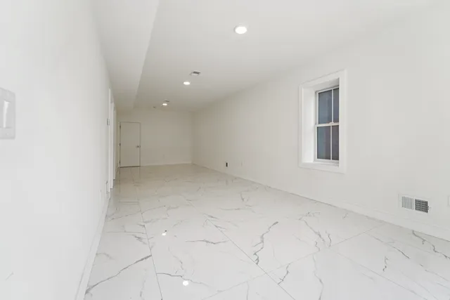 an empty room with a empty space and windows