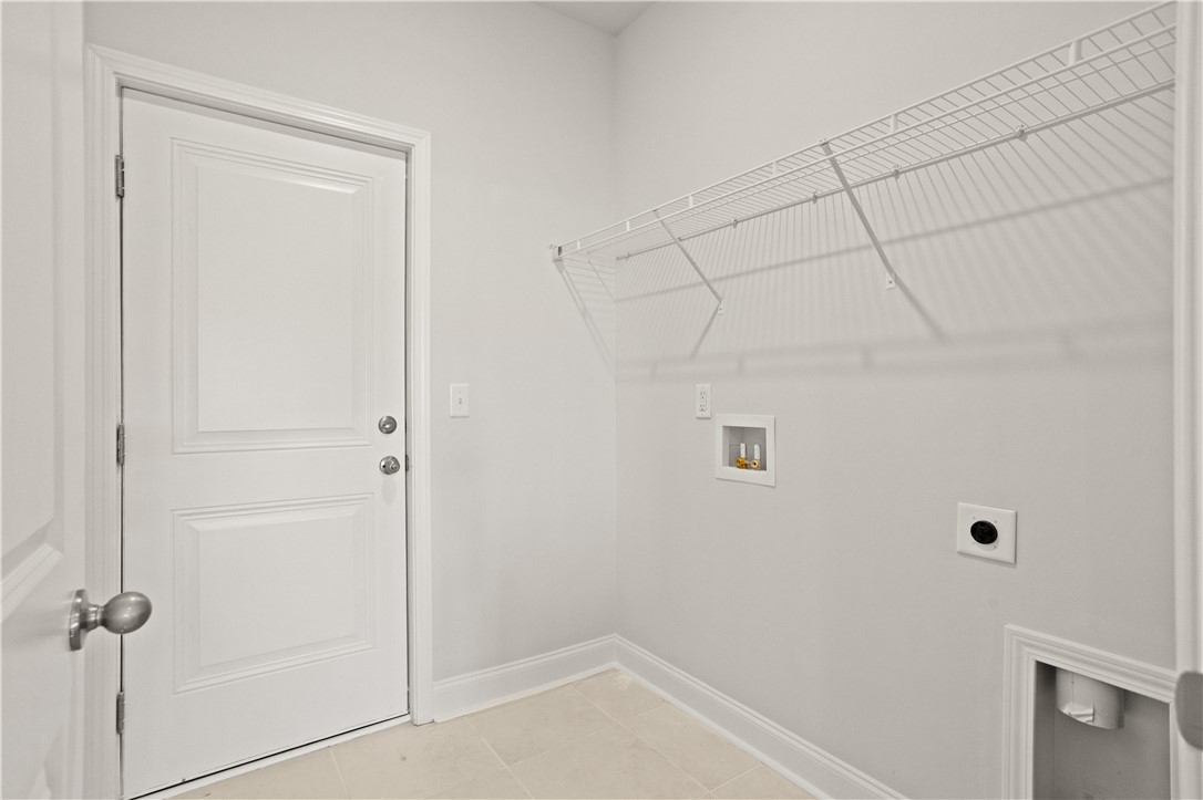 554 Hydrangea Street, Unit LOT 67 Seneca, SC 29678 - Photo 10 of 26 A well-organized utility space includes a convenient wire shelf and durable tiled flooring.