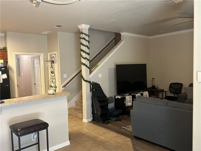 a living room with furniture and a flat screen tv